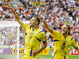Ukraines Andriy Shevchenko celebrates with team-mate Andriy Voronin after converting a penalty kick during the Group H match against Tunisia in Berlin on Friday