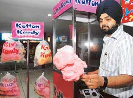 Winding candy floss on the stick. 