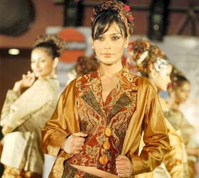 A model displays an outfit from fashion designer Vaishali Patels collection during the annual award distribution ceremony of the National Institute of Fashion Design (NIFD) in Ahmedabad
