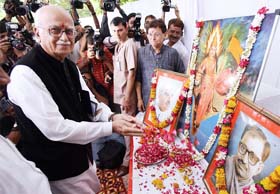 BJP leader and Leader of the Opposition in the Lok Sabha LK Advani offers floral tribute to the founding members of the BJP during a 'Save Democracy Day' function in New Delhi