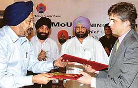 Mr Francois Lavergne, President, ESMOD International Fashion School, Paris , and Mr Jagjit Singh Kochar, CEO, Fashion Technology Park, Mohali, exchange MOU files in the presence of Punjab Chief Minister Amarinder Singh at Hotel Mountview in Chandigarh on Wednesday.