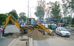 A Municipal Corporation ditch machine lays drainage pipes in the centre of the GT Road near PAP T-Point in Jalandhar