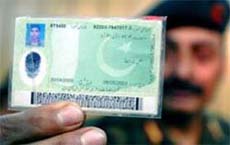 An Army officer displays the election card issued by the Pakistani authorities to one of the two Kashmiri militants
