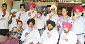 Where are our sons? Parents of missing youths display their photographs in Ludhiana on Wednesday.