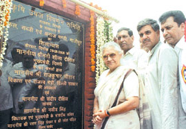 Chief Minister Sheila Dikshit unveiling the foundation stone of a new Food, Vegetable and Grain Market at Ghazipur in East Delhi as MP Sandeep Dikshit and Development Minister Rajkumar Chauhan look on.