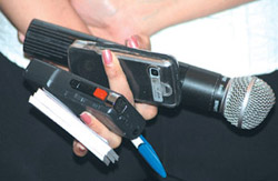 This woman journalist wants to leave nothing to chance as she enters a press conference armed with a tape recorder, camera phone, pen and a microphone.