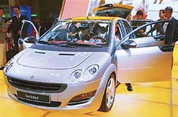 A four-seater smart car is seen in Tokyo in a 2003 file photo. DaimlerChrysler has struck a deal on compensating Mitsubishi Motors Corp for reducing the output of the mini car
