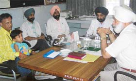 Mr Birdevinder, MLA, Kharar, listens to the father of Adarsh at the Civil Hospital in Mohali