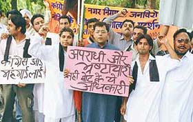 Members of the Bharatiya Janata Yuva Morcha raise slogans at an anti-Congress rally in front of the Municipal Corporation office in Sector 17, Chandigarh