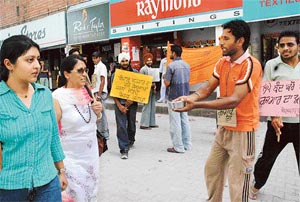 A member of the Berozgar PTI Teachers Union (Punjab) begs for alms in protest against the Punjab Government not listening to their demands in Chandigarh on Friday. 