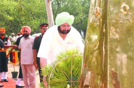 Chief Minister Captain Amarinder Singh lays wreath at a memorial during the Raising Day function of a battalion in Jalandhar Cantonment on Saturday