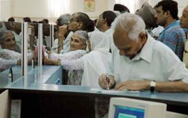 Pensioners queue up at a bank counter to get their montly pension on the first day of the month in Ludhiana