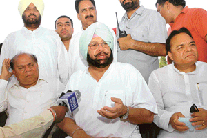 Punjab Chief Minister Captain Amarinder Singh talks to mediapersons at the PAP helipad in Jalandhar on Sunday. 
