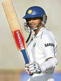 Rahul Dravid raises his bat after scoring a half century on the second day of the fourth Test in Kingston on Saturday. 