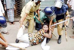 Police officers detain an Opposition activist in Dhaka