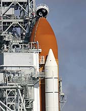 The top of the external fuel tank under the space shuttle Discovery is seen sitting on the launch pad
