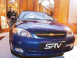 General Motors India Vice-President P. Balendran poses for photographs next to the newly launched Chevrolet SRV