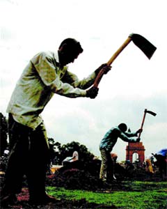 Rain or shine, these workers toil on near India Gate