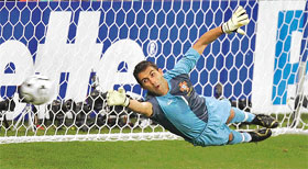 Portuguese goalkeeper Ricardo dives in vain to save a penalty kick shot by French midfielder Zinedine Zidane during the semifinal match against Portugal in Munich on Wednesday. 
