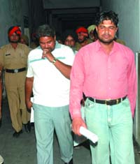 Head Constable Surjit Singh and Home Guard Balkar Singh come out of the district court after receiving the verdict in Jalandhar on Wednesday. 