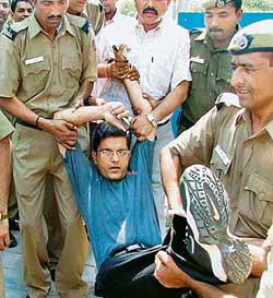 A medical student being removed from AIIMS Hospital where students were protesting against the removal of Dr P. Venugopal in New Delhi on Thursday.