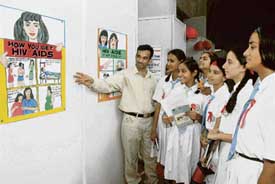 Schoolchildren watch the exhibition on AIDS and drug addiction, put up at PGIs Zakir Hall to mark the foundation day celebrations