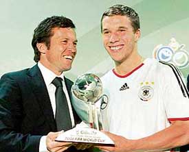 German football legend Lothar Matthaus hands over the FIFA Best Young Player award to Germanys star striker Lukas Podolski
