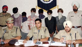 Police officials with members of the "Victory" gang arrested on Saturday