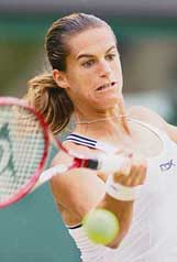 Amelie Mauresmo of France plays a shot against Belgiums Justine Henin-Hardenne in the womens singles final at Wimbledon on Saturday. 
