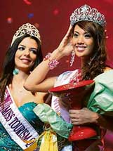 Ms Justine Gabionza from the Philippines (right) poses with the trophy after being crowned as the new Miss Tourism Queen International by last years winner Nikoletta Ralli of Greece in Hangzhou in China on Saturday. 