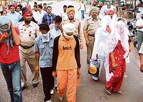 Six men and women arrested for operating a sex racket being taken to a court in Ludhiana