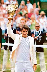 Switzerlands Roger Federer holds the trophy after beating Spains Rafael Nadal in the mens singles final at Wimbledon in London on Sunday. Federer won 6-0, 7-6, 6-7, 6-3 to claim his fourth consecutive Wimbledon title. 