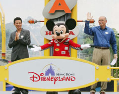 Singer Jacky Cheung (left), Mickey Mouse (centre) and Mr Bill Ernest, Executive Vice-President and Managing Director of Hong Kong Disneyland, attend the opening ceremony of Tommorrowland's new attractions at Hong Kong Disneyland 