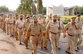 R.S. Randhawa (2nd from left), DSP of the Chandigarh Police, leads a team during a flag march on the Panjab University campus on Wednesday.