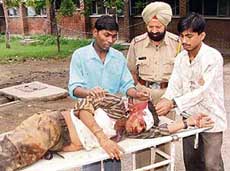 A labourer injured in the wall collapse being taken to hospital in Ludhiana on Wednesday.
