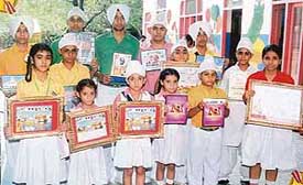 Students of Spring Dale Senior Secondary Public School happily pose with the awards they won in different competitions on the occasion of Guru Hargobind's birth anniversary in Ludhiana on Wednesday.