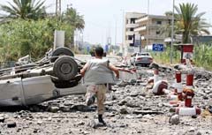 A Lebanese civil defence representative runs shortly after Israeli warplanes bombed Qasmiya Bridge near Tyre in south Lebanon