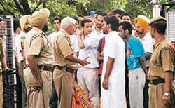 Police officers mollify agitating activists at PU, Chandigarh, on Thursday. 