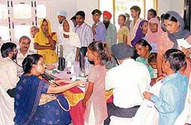 Patients being examined by a team of doctors during a free medical camp at Ladowal in Ludhiana