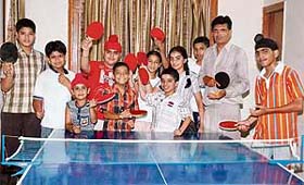 Budding paddlers with their trainer, Jawahar Lal Bhandari, after a practice session in Ludhiana