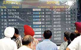 A notice board at the domestic airport in New Delhi displays flight delays on Thursday