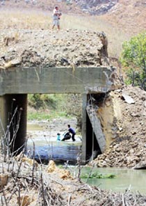 Lebanese civilians inspect Litani bridge that was attacked by Israeli warplanes in south Lebanon