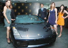 Models along with Mr Stephen Winkelmann, President and CEO of Lamborghini, pose with Gallardo, the compact two-seater high-performance sports luxury car, launched in New Delhi 