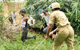 Policemen chase demonstrating teachers of the Lok SHiksha Sangh in Patna on Thursday. The teachers were demanding a hike in salary and other facilities.