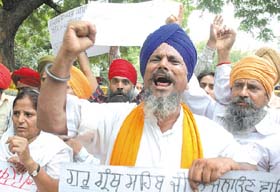 Sikh activists demanding an inquiry into the fire at Gurdwara Sri Guru Singh Sabha (Shaheedi Sathan), in the Capital