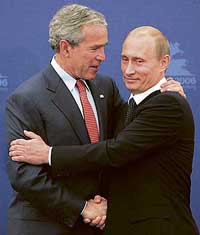 Russian President Vladimir Putin and US President George W. Bush greet each other as they enter the hall for their news conference after talks in St Petersburg on Saturday.