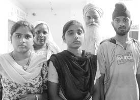 Gurnam Singh, a daily wage worker, stands proud with his children, whom he has educated to become doctors and engineers. Photo by the writer