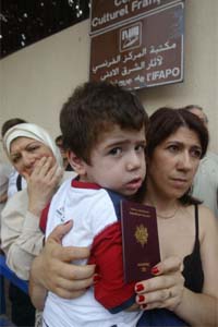 French citizens stand in a queue in front of the French Embassy on Sunday that will make arrangements to evacuate them from Lebanon.