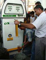 A BPL official collects samples from a petrol station in Ludhiana on Monday