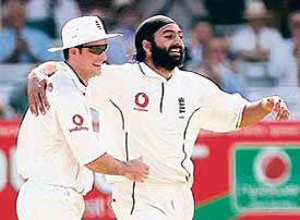 Englands Monty Panesar celebrates with captain Andrew Strauss after dismissing Pakistans Faisal Iqbal on the fifth day of the first Test at Lords on Monday